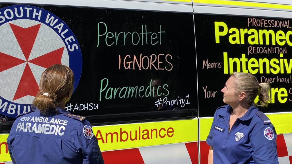 Dubbo paramedics and ADHSU members chalk the side of their ambulance with a message to NSW Premier Dominic Perrottet. Picture supplied