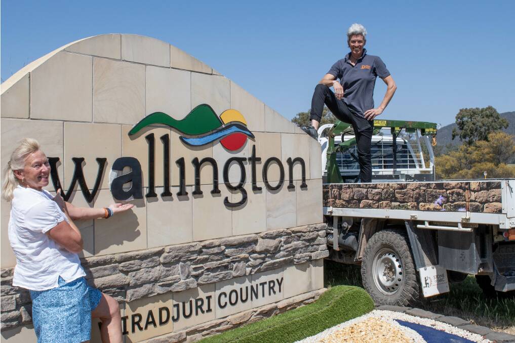Lisa Thomas, arts curator of Wellington Arts and Emma Knowles, owner of Stone of Arc, at the Wellington town sign which they have changed to read 'Wallington' for the picture. Picture by Belinda Soole