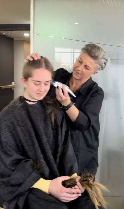 Julie Farr shaves her daughter Georgia Farr's head for the World's Greatest Shave. Pictures supplied