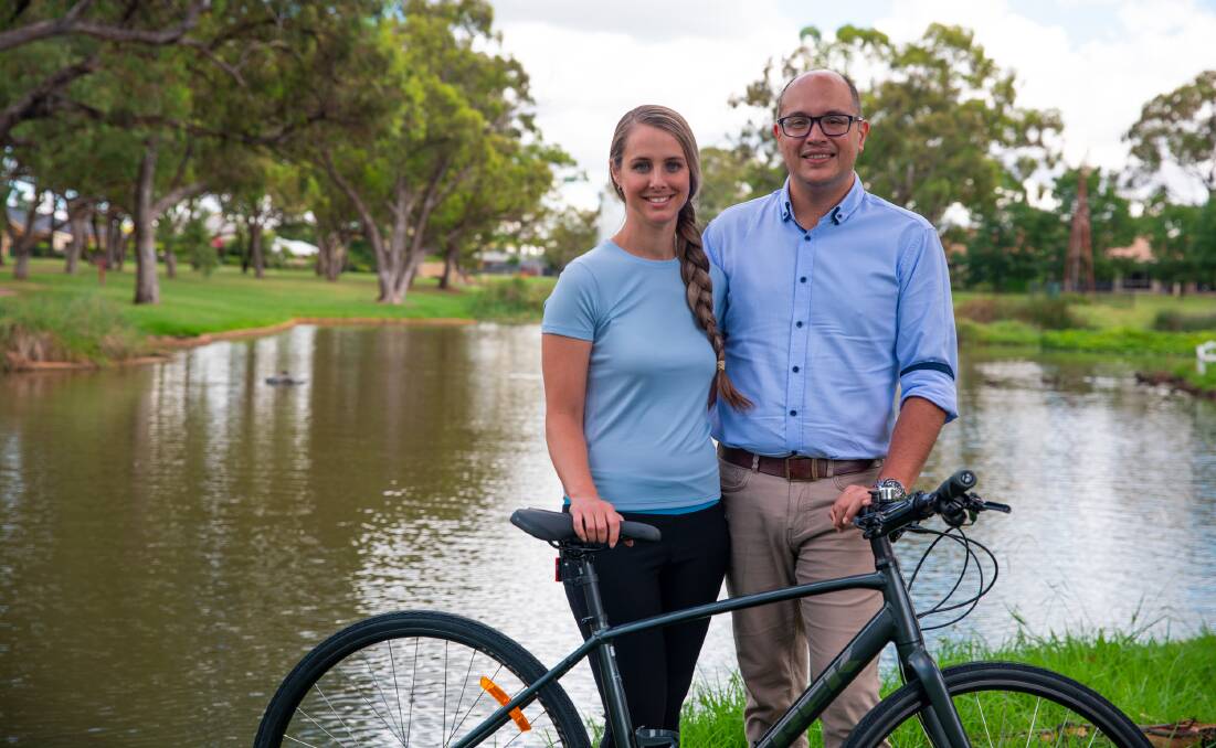 Giving back: SJ Shooter Real Estate's Laura Shooter (left) with her husband Samuel Shooter. Mr Shooter will be looking after the couple's two kids while his wife rides 5000 kilometres to raise money for kids in Thailand. Photo: CONTRIBUTED