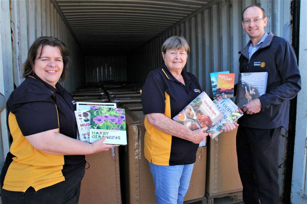 Nicole Shanks, Pam Sharkey and Colin Shanks of Dubbo West Rotary Club prepare to unload around 30,000 books from a shipping container to send to Dubbo Showground for the annual Michael Egan Memorial Book Fair. Picture by Elizabeth Frias