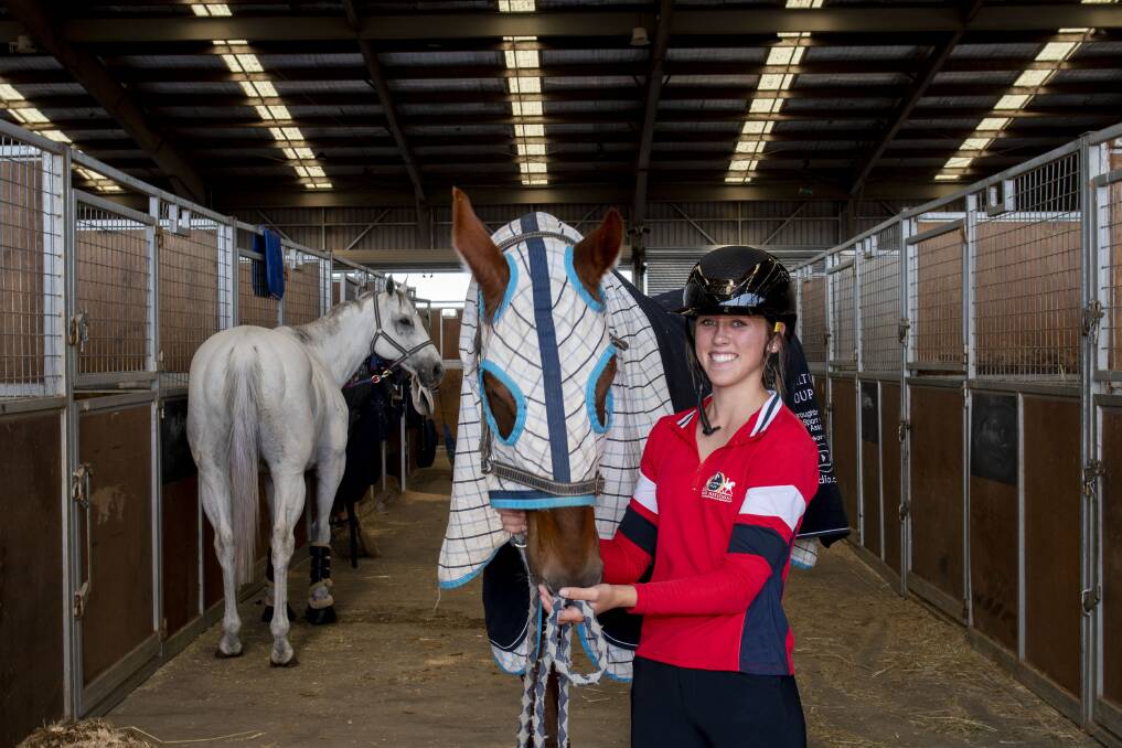 Elise Smith, 15 from Bourke, with her horse Alvern as she prepares to compete in Showjumping events. Picture by Belinda Soole