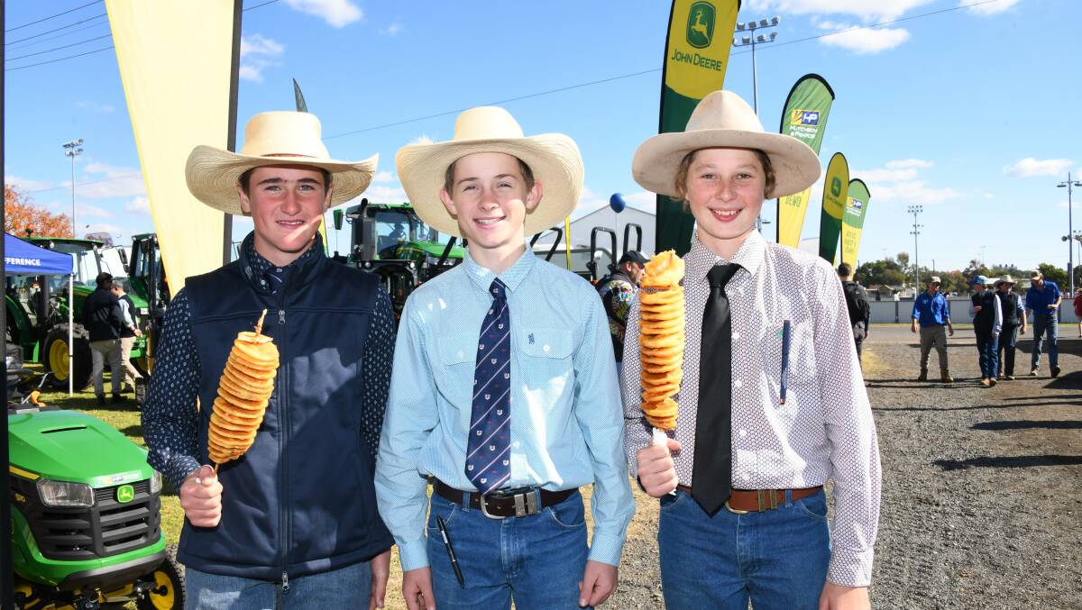 Lachlan Hooper, Harry Kidd and Charlie Duffy with chips on a stick at the 2023 Dubbo Show. Picture by Amy McIntyre