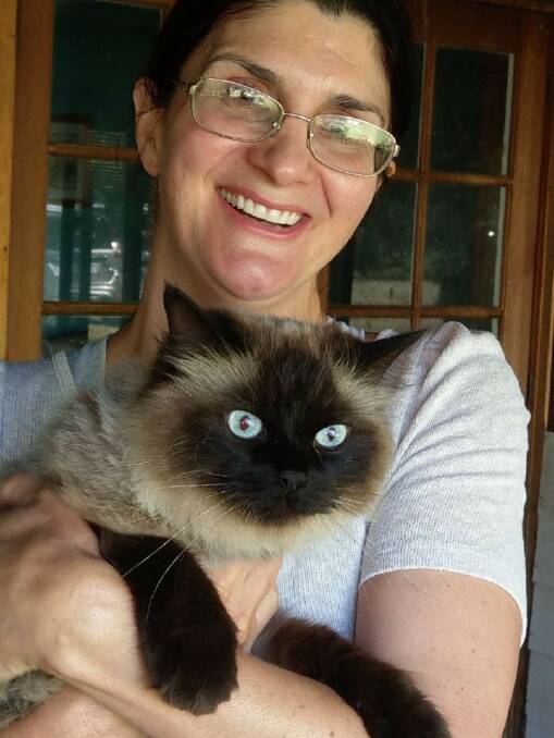 A cat named Alfie, adopted from AWL NSW Dubbo Volunteer branch, with his new owner. Photo: CONTRIBUTED