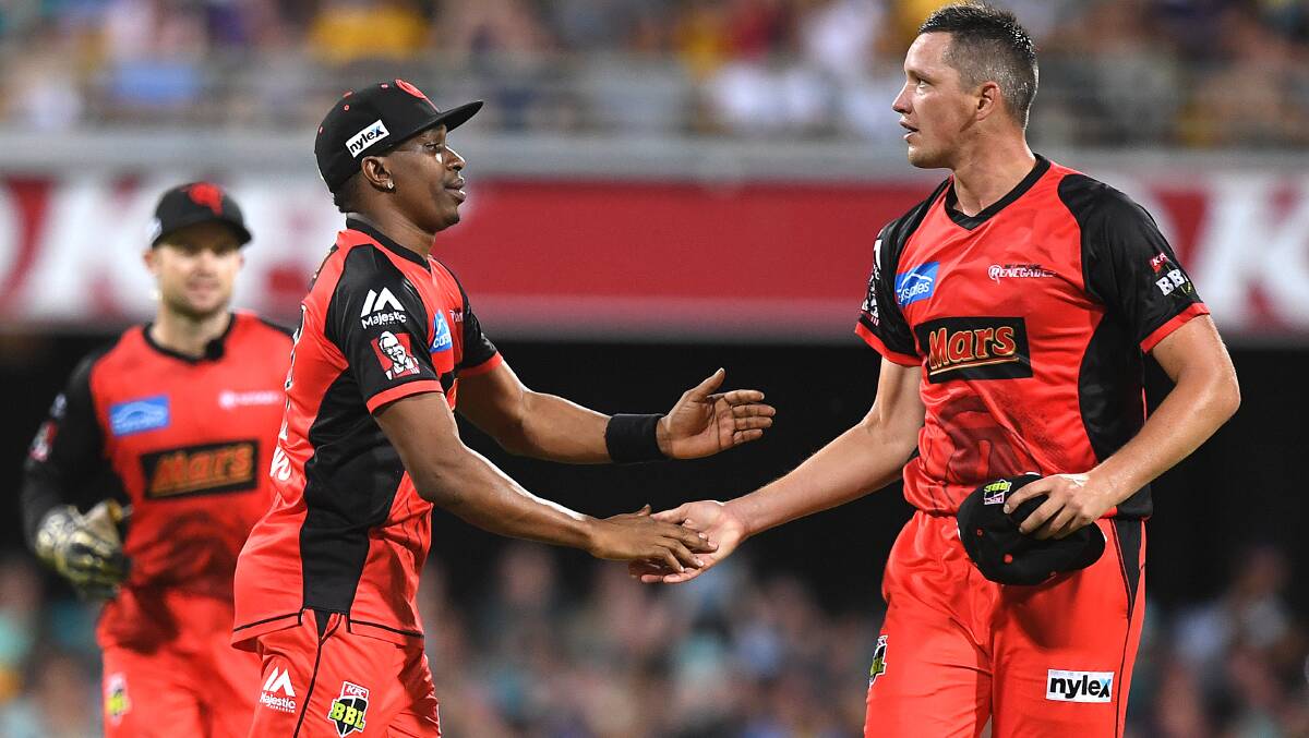 GET ON RED: Chris Tremain (right) celebrates a wicket with Dwayne Bravo during last summer's Big Bash League. Photo: AAP