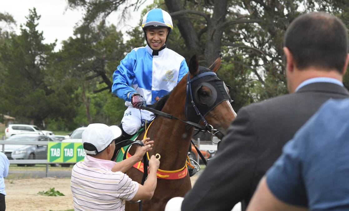 WINNER: Qin Yong brings fourth-race winner Jin Chi Phantom back to the yards, his victory came after a Kody Nestor double early in the meeting. Photo: JUDE KEOGH