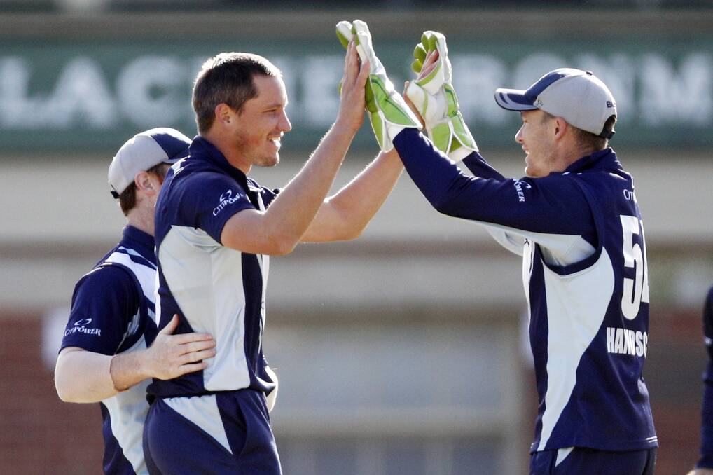 CRUCIAL POLE: Chris Tremain celebrates one of his two wickets in Wednesday's win with captain Pete Handscomb. Photos: AAP/DANIEL POCKETT