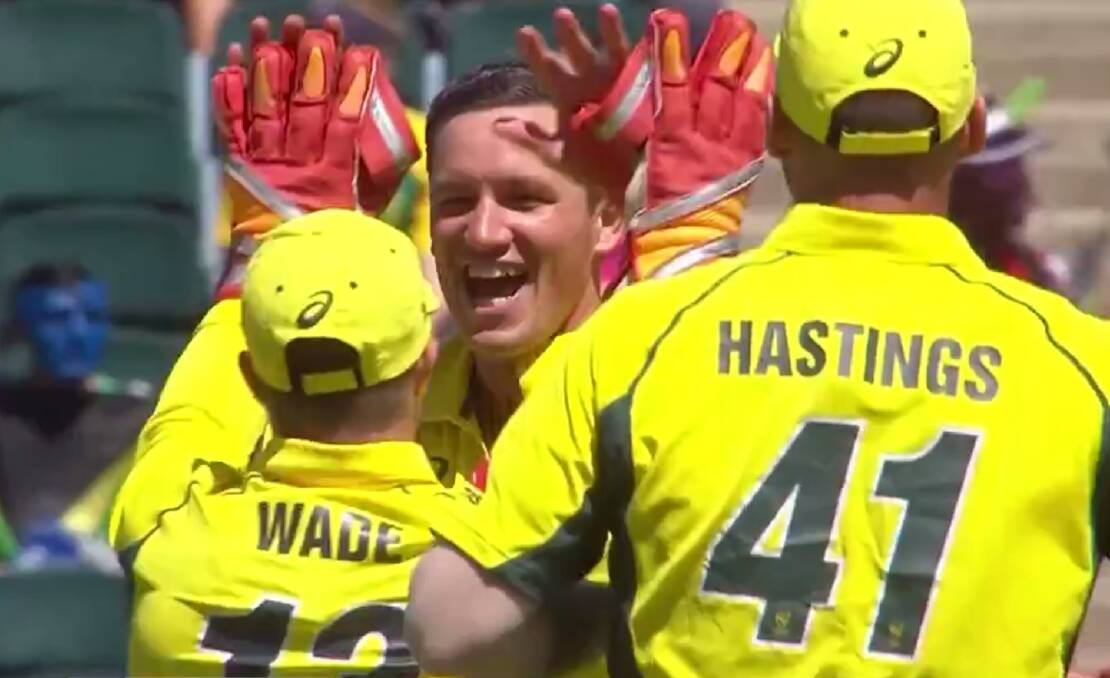 SCALP: Chris Tremain celebrates his maiden international wicket with Matthew Wade and John Hastings.