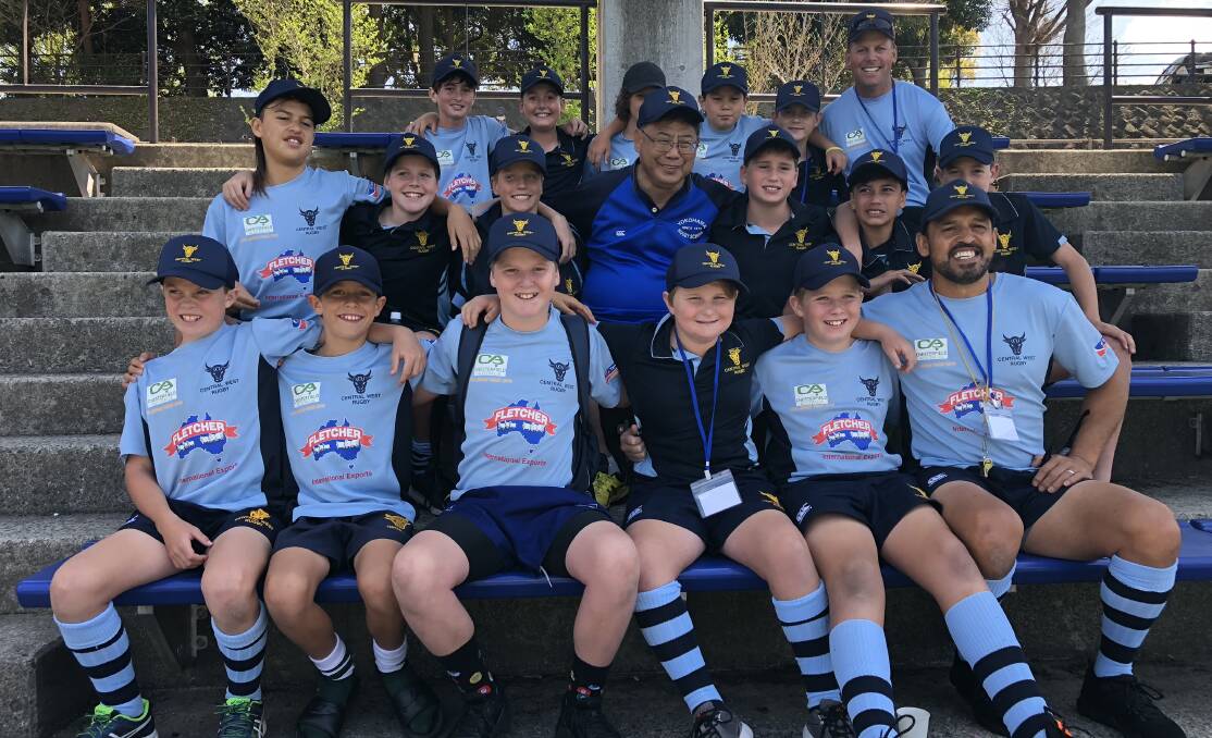 LEARNING EXPERIENCE: Central West's under 12s following a training sessions in Japan, with Kids' Rugby World Cup tournament manager 'Gotcha' (middle). Photo: WILL GADEN