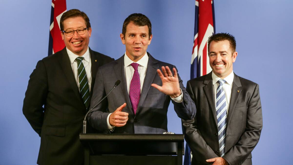 HEADS ON: Dubbo MP Troy Grant (left) and Bathurst MP Paul Toole (right) - pictured with former premier Mike Baird - have rejected Labor claims of a spending shortfall in regional NSW. Photo: FILE