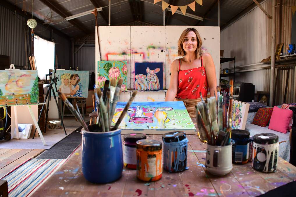 Buoyant: Dubbo artist Jacinta Haycock in the studio from where she has sent paintings to new buyers found through the Buy from the Bush movement. Photo: BELINDA SOOLE 