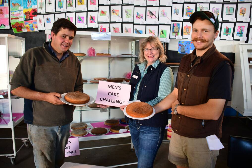 SHOWTIME: Wes Temessl and Bradley O'Leary deliver their cinnamon tea cakes to cookery section chief steward Belinda Edmondson on Thursday morning for judging. Photo: BELINDA SOOLE