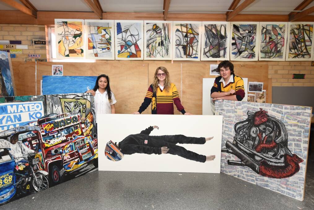Creative: Hannah Sandoval, Grace Gilbert and Blake Browning with their HSC major art pieces. Photo: Belinda Soole 