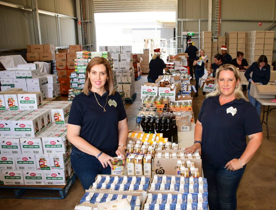 SEASONAL SPIRIT: Aussie Helpers CEO Natasha Kocks, with depot manager Katie O'Brien during the packing. PHOTO: BELINDA SOOLE.