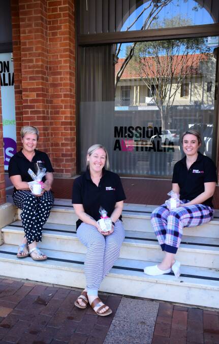 RAISING AWARENESS: Mission Australia's Ally Niemeyer, Emma Artery and Megan Boshell want families to stay in their PJs this weekend. Photo: BELINDA SOOLE
