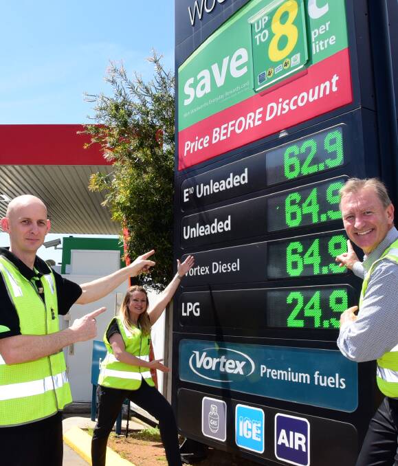 HAPPY BIRTHDAY: Woolworths Caltex's Ben Bailey, Suzzanne Houghton and Angus Armstrong celebrated their 20th anniversary on Thursday by taking their petrol back to its 1996 prices. Photo: BELINDA SOOLE