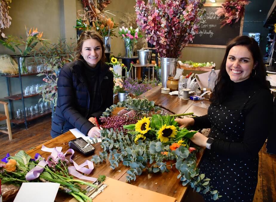 Thanks a bunch: The Meadow Floral Design founder Irissa Knight (right) and team member Sally Kay fulfill bouquet orders. Photo: BELINDA SOOLE