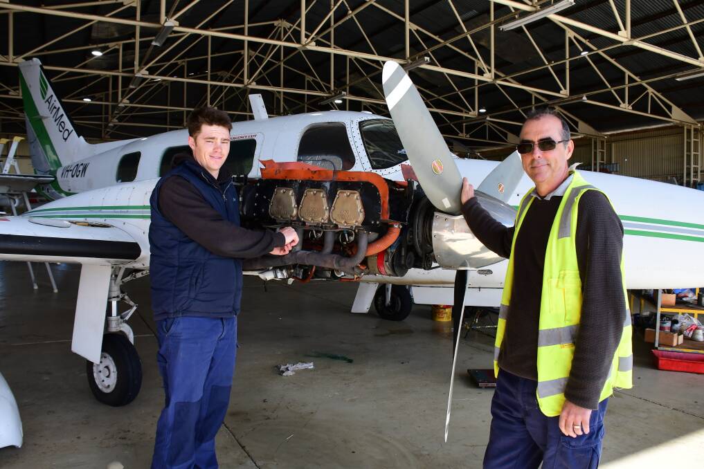 Passion: New Air Link employee Pat O'Shea (right) at work in Dubbo with aircraft maintenance engineer Ryan Riley. Photo: BELINDA SOOLE