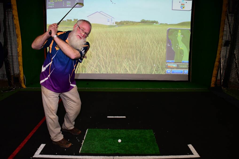 INTO THE SWING OF IT: Sportsworld manager Greg King with the new golf simulator now available at the centre. Photo: BELINDA SOOLE