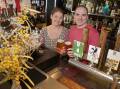 Cheers: The Monkey Bar owners Tim and Cass Smith with the wild ale they brewed in The Pilot Room, fermented using wild yeast foraged from local wattle flowers. Picture: BELINDA SOOLE
