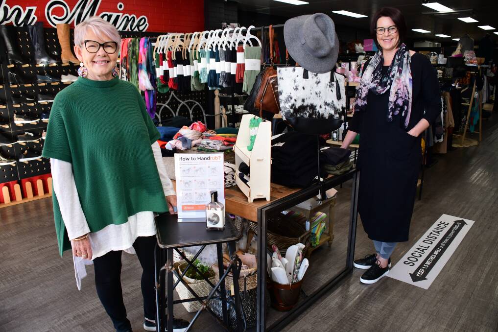 Comeback: Ruby Maine owners Rhonda Cooper and Samantha Portelli reopen the boutique, with hand sanitiser and signs to prompt social distancing. Photo: BELINDA SOOLE 