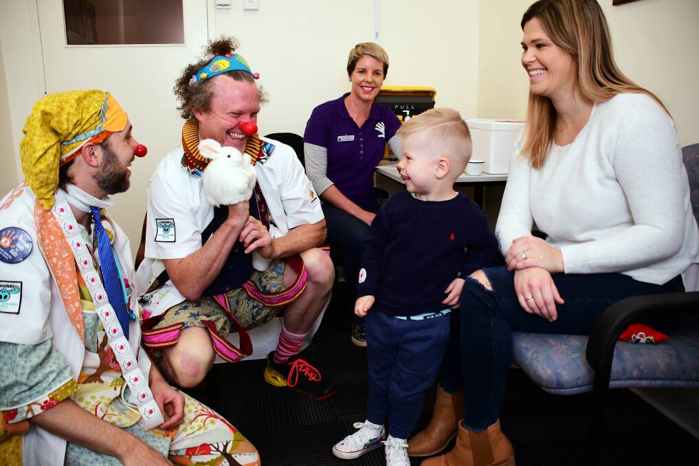 LAUGHING MATTERS: Dr Snooze Pablo Latona and Dr Toot Andy McDonnell with Kim Rice Child and Family Health Nurse and Kai and Mel Matheson. Photo: BELINDA SOOLE. 
