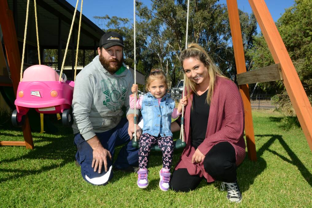 AWARENESS: Two-year-old Aurora with her parents Daniel Bruce and Sarah Bramston during the Miracle Month of May. Photo: BELINDA SOOLE