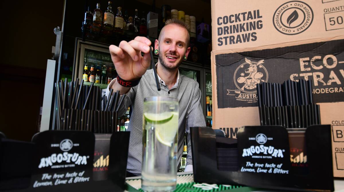Switch it: Old Bank Restaurant and Bar licensee Ryan Mackintosh with the new straws that will break down, rather than harming the environment. Photo: BELINDA SOOLE