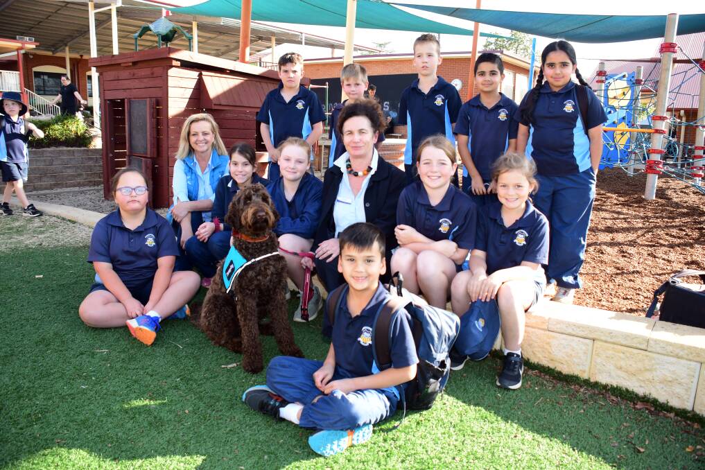 GOOD BOY: Therapy dog Wally with St Laurence's students, principal Susan Byrnes and trainer Samantha Kay. Photo: BELINDA SOOLE