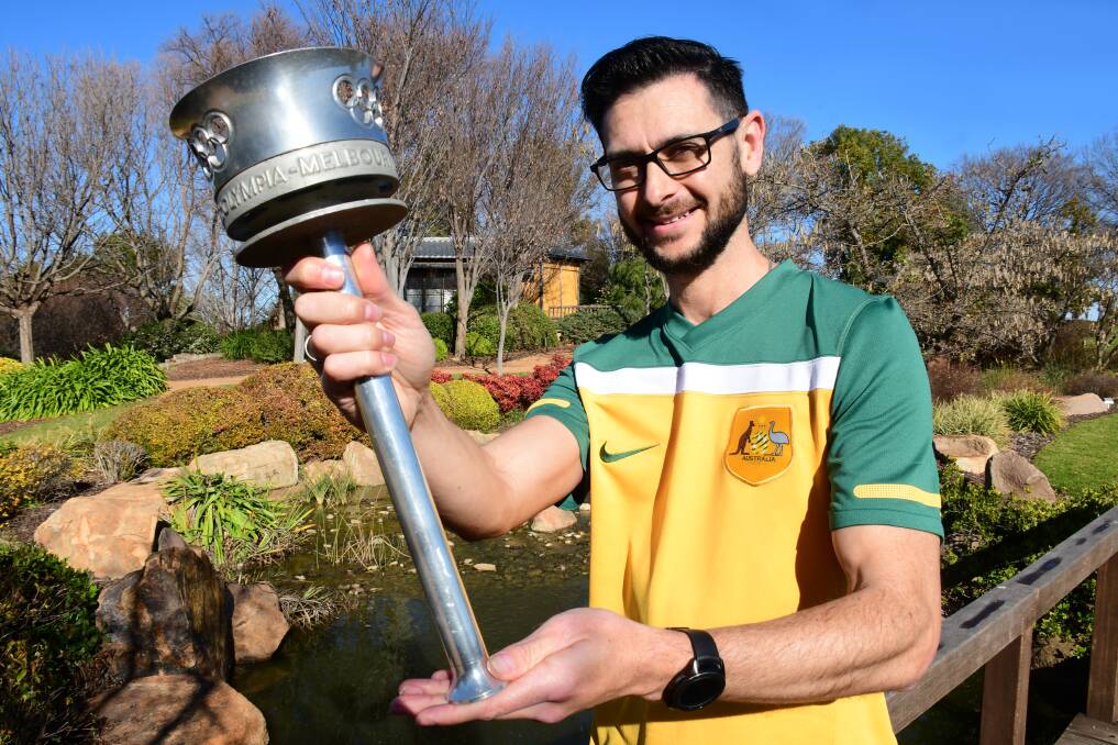 CONNECTED: Steve Gamble with the 1956 Melbourne Olympic Games torch his family owns. Photo: BELINDA SOOLE