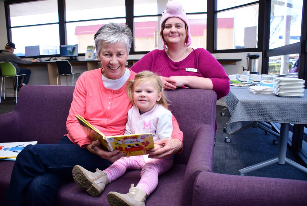 CELEBRATING READING TOGETHER: Mary Strong and her two-year-old granddaughter Lucy Horn celebrating Australian Reading Hour with Kate Babic at the Dubbo branch of Macquarie Regional Library. Photo: BELINDA SOOLE 