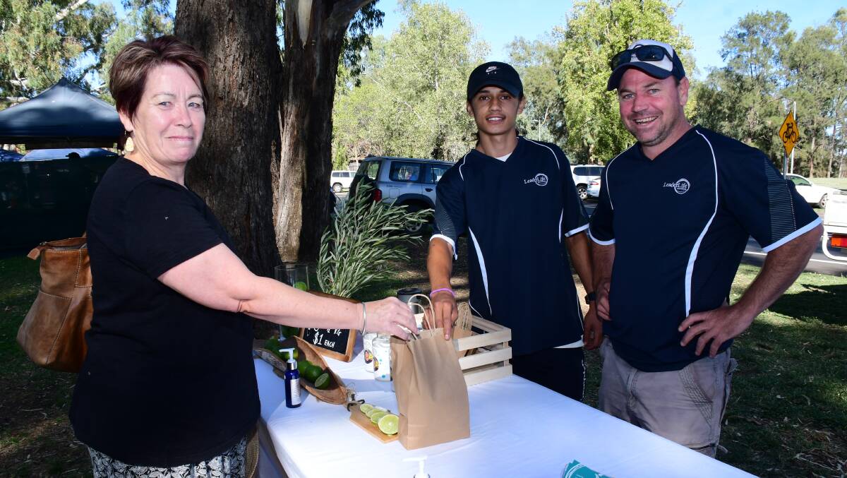 FOR SALE: Happy customer Sue Buttrey with Hank Hammond and Scott Quigley at the recent Farmers Markets. Photo: BELINDA SOOLE
