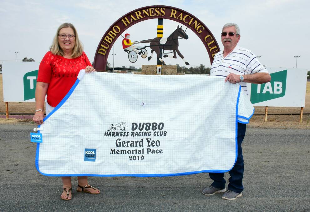 HONOURED: Dubbo Harness Racing's Len and Virginia Edwards hold aloft the rug that will be presented to the winner of the Gerard Yeo Memorial Pace. PHOTO: BELINDA SOOLE.