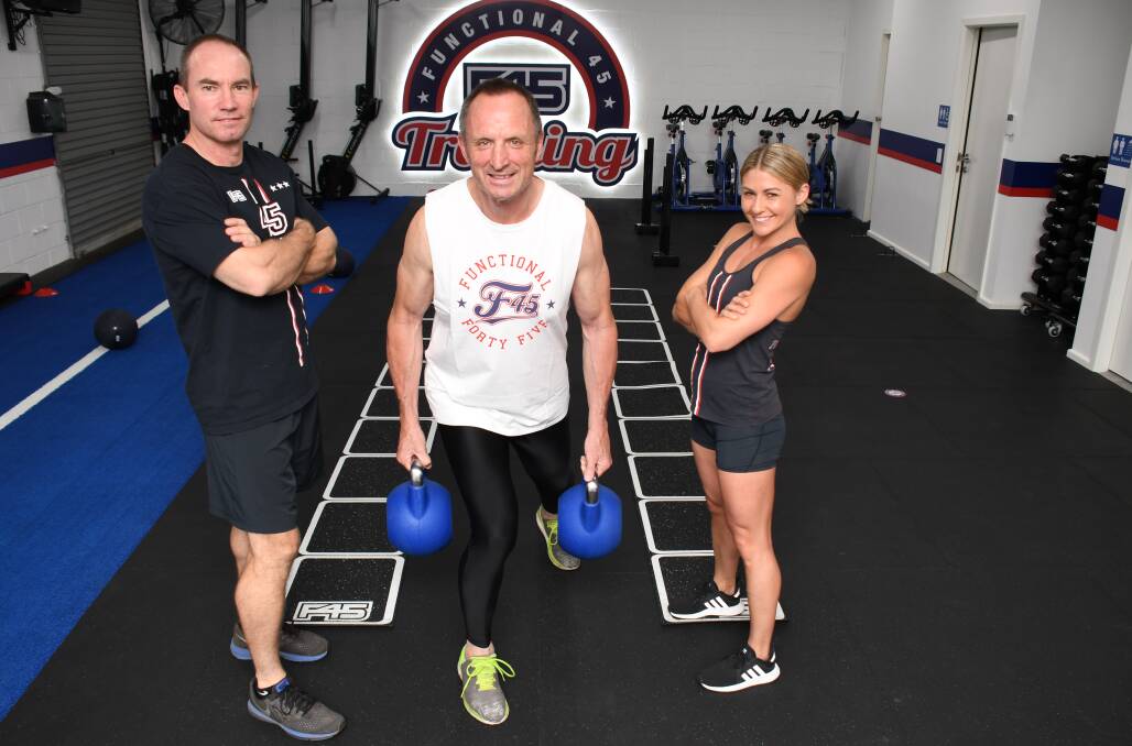 TRANSFORMATION: F45 Dubbo trainers Jason Poulson and Ash Clauser watch  Adrian Rovere (centre) work out. Photo: BELINDA SOOLE