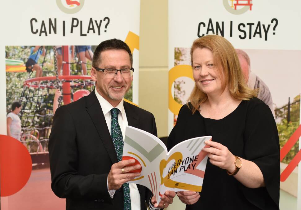 EVERYONE CAN PLAY: Dubbo Regional Council's Ian McAlister and Commissioner for Open Space and Parklands Fiona Morrison confer on the draft guidelines for making playgrounds inclusive. Photo: BELINDA SOOLE