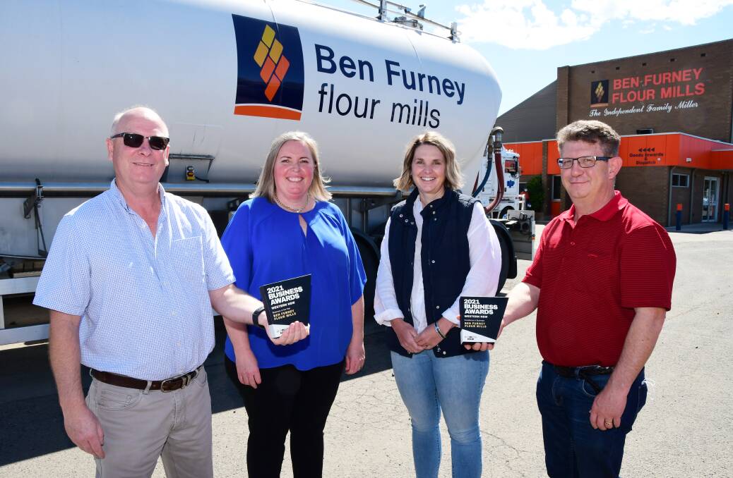 WIN: Business NSW's Vicki Seccombe (second left) presents the Western NSW Business Awards trophies to Ben Furney Flour Mills risk and compliance manager John Howell, CEO Sarah Furney and operations manager Gary Schubel. Photo: BELINDA SOOLE