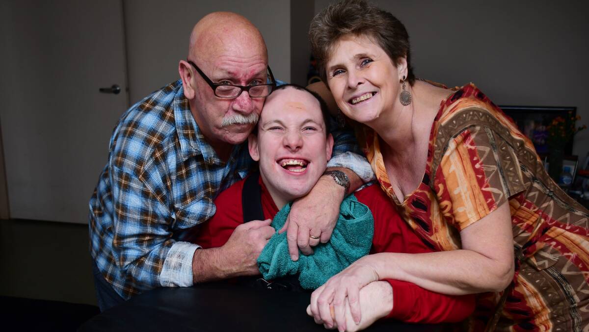 COMMUNITY CARE: Support workers set out to help new family, Mark and Deborah Hanlon with nephew Mitchell Newman. Photo: BELINDA SOOLE. 