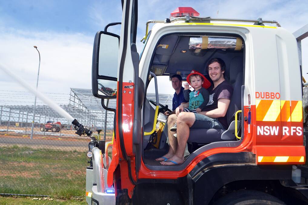 FIRE PREPARATION: Rural Fire Service firefighter Nathan Parsons with Arthur and Leigh Rice at the open day. Photo: BELINDA SOOLE.