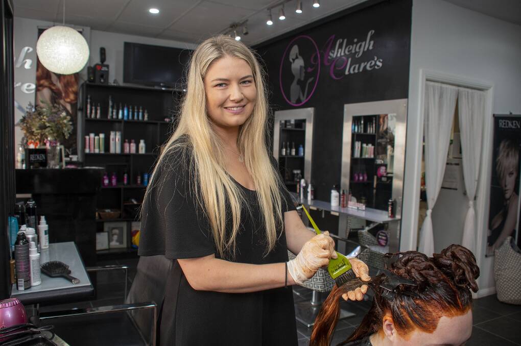 BUSY: Hairdresser Ashleigh Banfield. Picture: BELINDA SOOLE