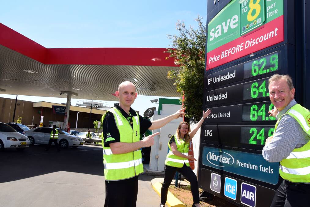 HAPPY BIRTHDAY: Woolworths Caltex's Ben Bailey, Suzzanne Houghton and Angus Armstrong celebrated their 20th anniversary on Thursday by taking their petrol back to its 1996 prices. Photo: BELINDA SOOLE