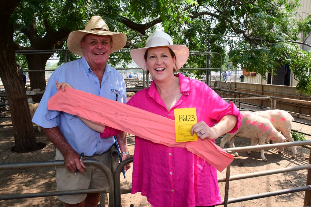 THINK PINK: Auctioneer Peter Cruickshank with one of the winning bidders Kylie Walsh at the annual charity auction, which raised $10,000. Photo: BELINDA SOOLE