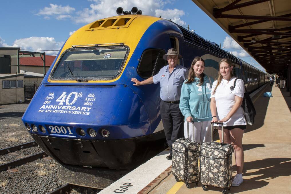 Milestone: NSW TrainLink regional train driver Tony Riley with travellers Hayley and Amber Dunn alight at Dubbo in the XPT's 40th birthday week. Picture: BELINDA SOOLE