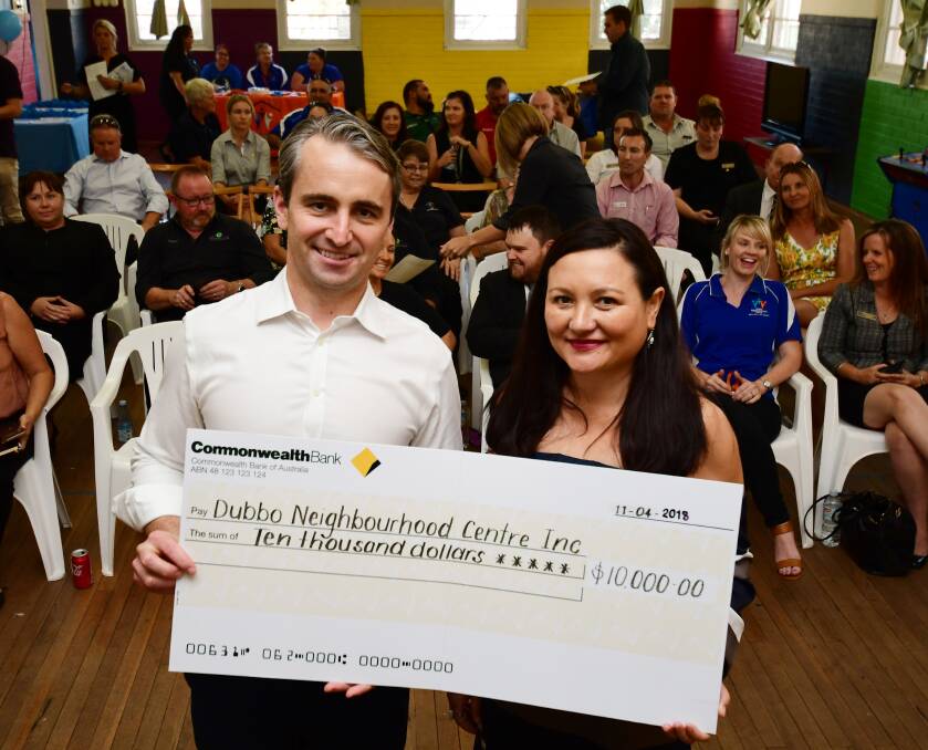 SPECIAL DELIVERY: Commonwealth Bank chief executive officer Matt Comyn presents the grant in the form of a large cheque to Dubbo Neighbourhood Centre chief executive officer Michelle Redden. Photo: BELINDA SOOLE