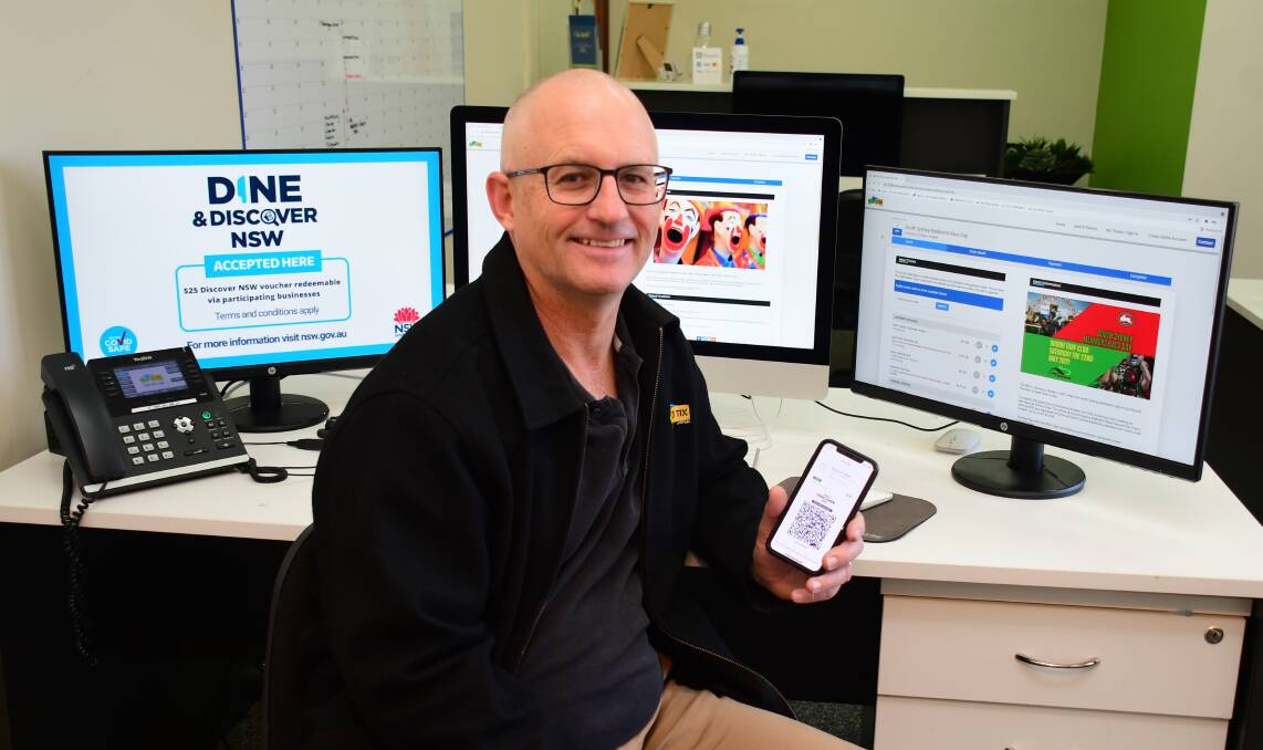 Easy: 123 Tix director Terry Wilcher with his online ticketing platform that is now ready for customers to redeem their $25 Discover NSW vouchers. The vouchers must be used by June 30. Photo: BELINDA SOOLE