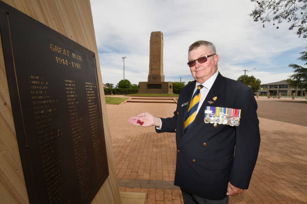 Honouring sacrifice: Dubbo RSL sub-branch president Tom Gray holds a poppy and encourages people to attend the ceremony. Photo: BELINDA SOOLE