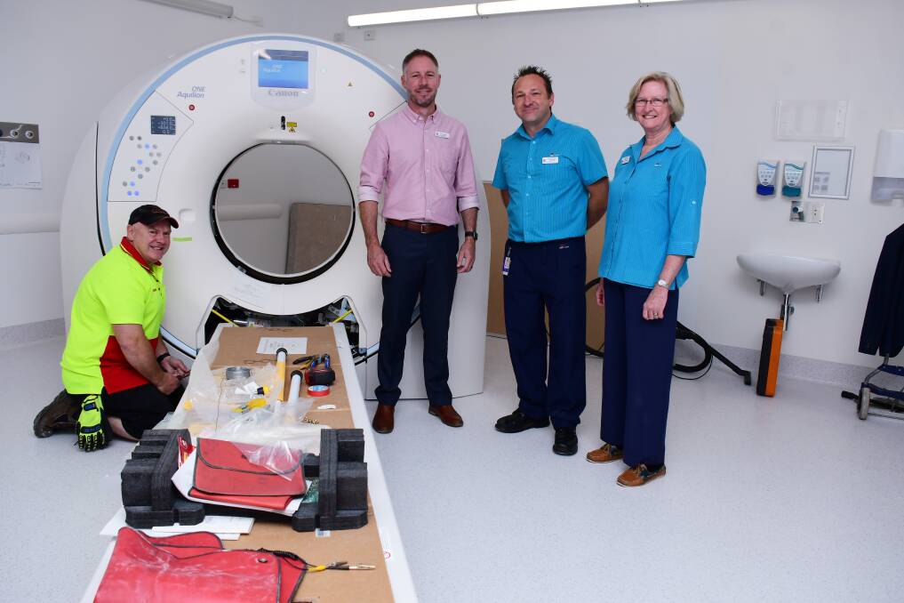 FIRST IN AUSTRALIA: Canon service engineer James Hoban, Western NSW Local Health District chief executive Scott McLachlan, radiographers James Corfield and Di Townsend inspect the Canon CT scanner. Photo: BELINDA SOOLE