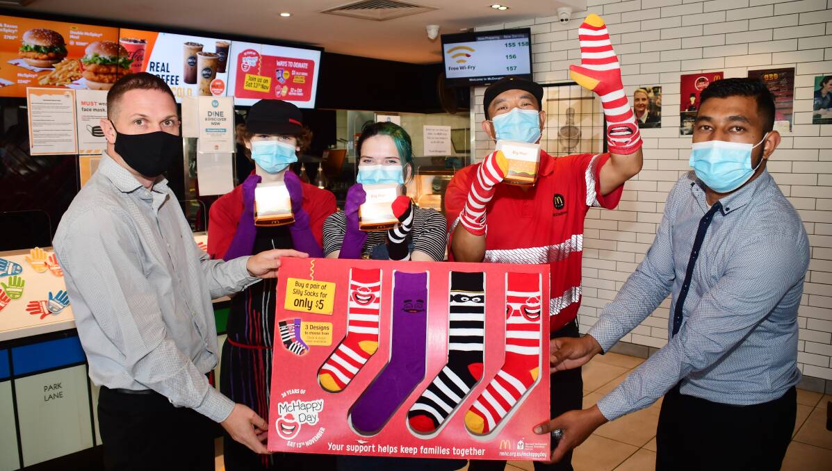 SILLY SOCKS: McDonald's Dubbo supervisor Ben Hyde with employees Noah Fenton, Isabelle McAnally, Ramsey Pigangay and manager Sujit Shrestha. Photo: BELINDA SOOLE
