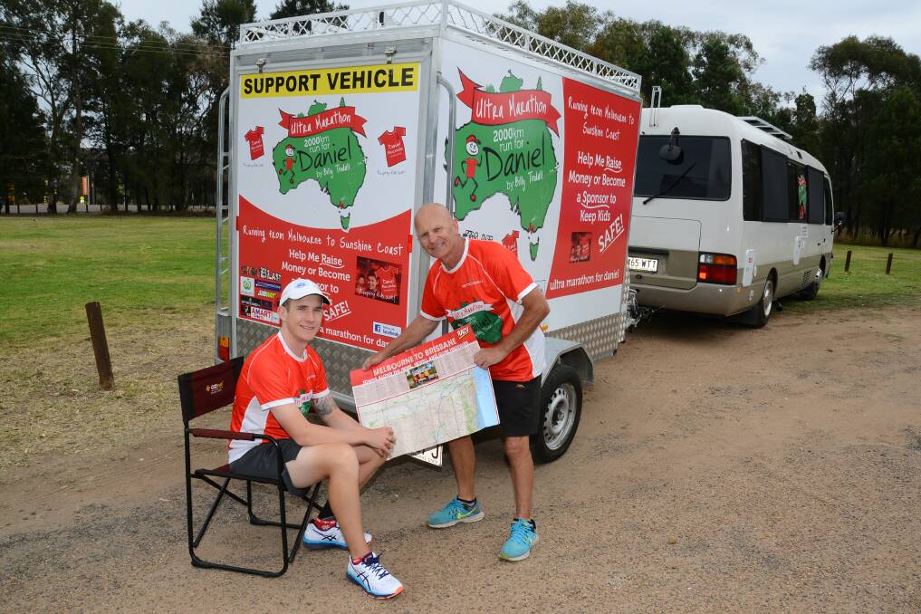On the road: Billy Tindall and Gary Parsons plot their next section of Billy's 2000-kilometre journey for  the Daniel Morcom Foundation. Photo: BELINDA SOOLE