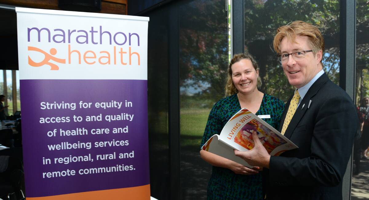 FINDING SOLUTIONS: Marathon Health's Jessica Brown and Mental Health Australia's Frank Quinlan talk about psychosocial disability and the National Disability Insurance Scheme at a meeting in Dubbo. Photo: BELINDA SOOLE