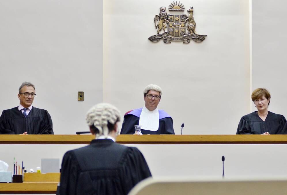 NEW YEAR: Magistrate Gary Wilson, Judge John North and Magistrate Claire Girotto listen as Barrister Joe Kellaway addresses the court. Photo: BELINDA SOOLE